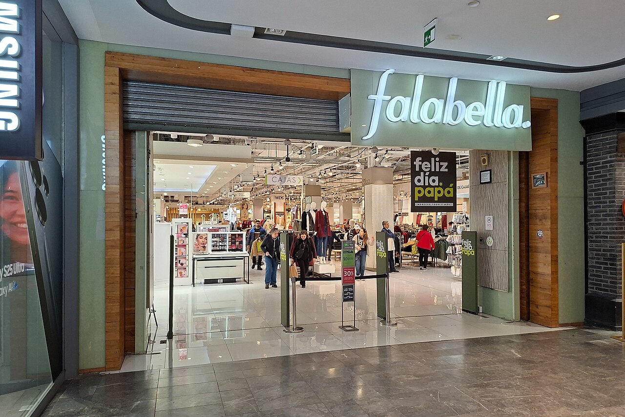 Shoppers walk through the entrance of a Falabella department store inside a shopping mall in Santiago, Chile