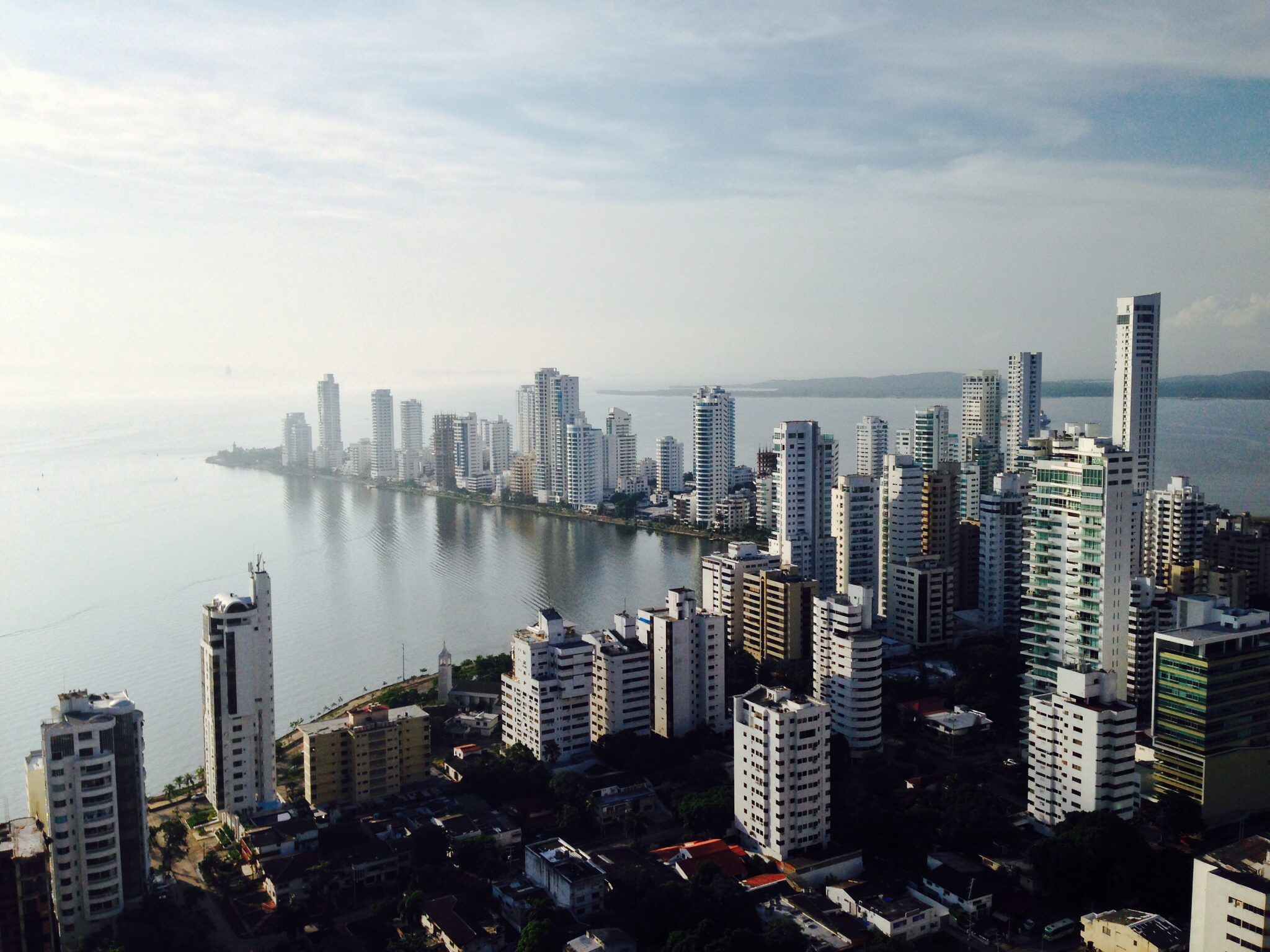 High-rise apartment towers along the Bocagrande waterfront of Cartagena beside a calm bay.