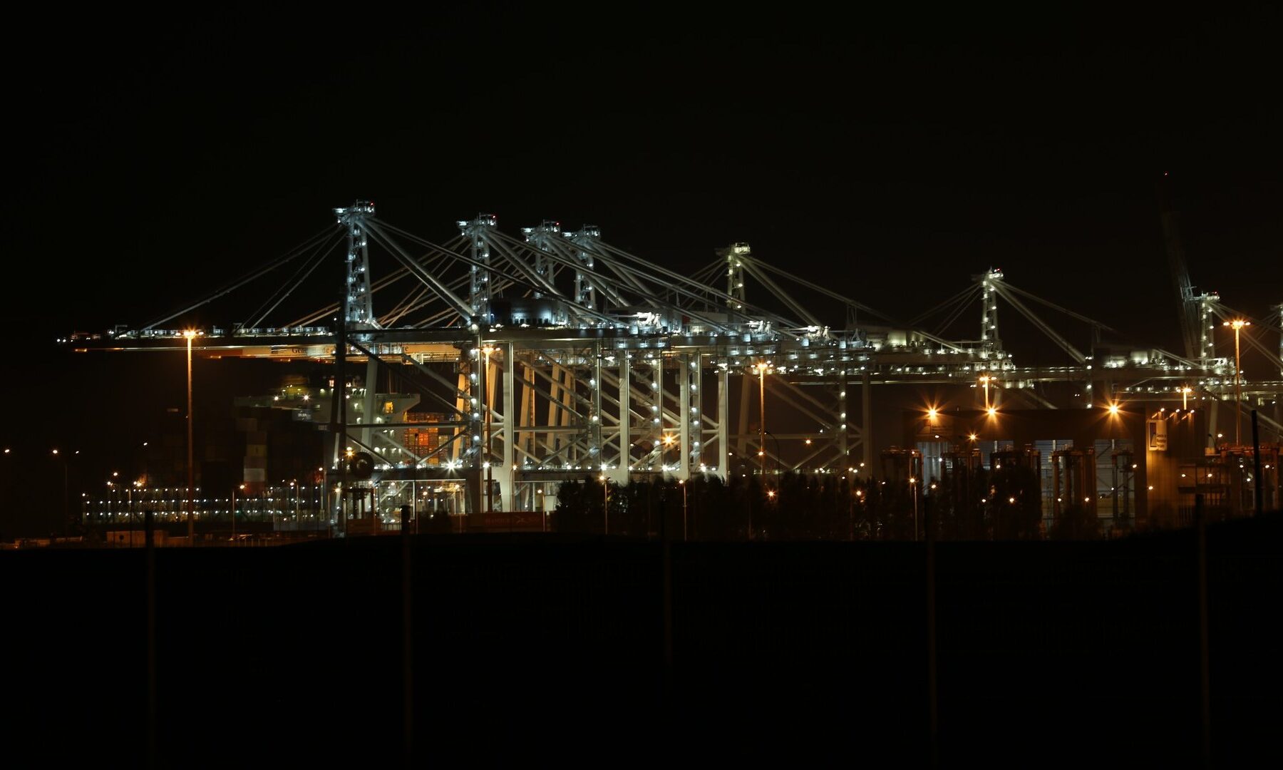 Container cranes lit at night at Port 2000, Le Havre, France