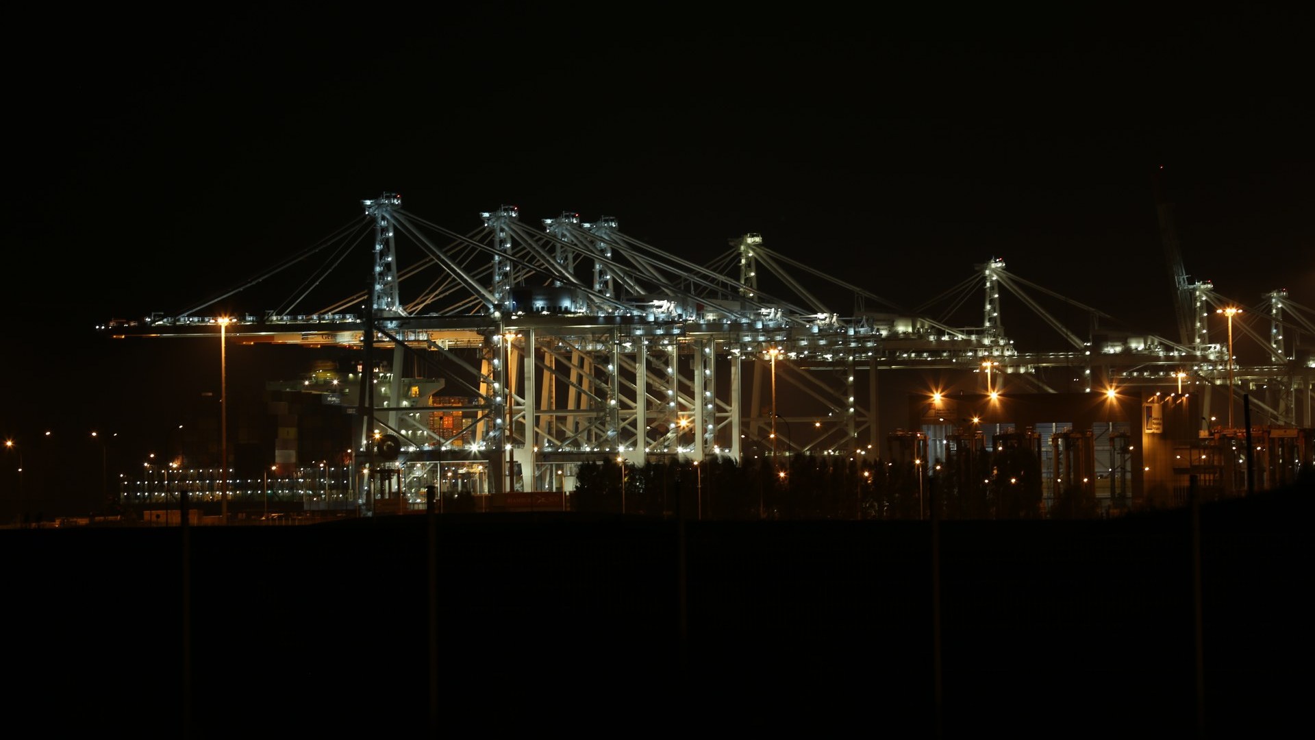 Container cranes lit at night at Port 2000, Le Havre, France's largest container port