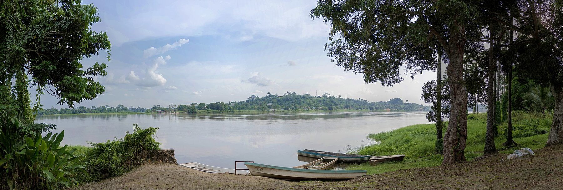 The Ogooue River at Lambarene in central Gabon, with boats on the bank