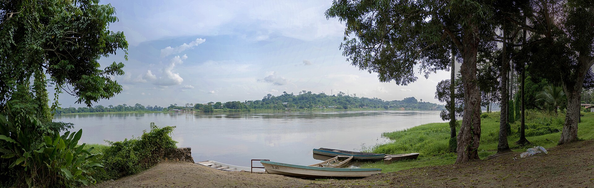 The Ogooue River at Lambarene in central Gabon, with boats on the bank