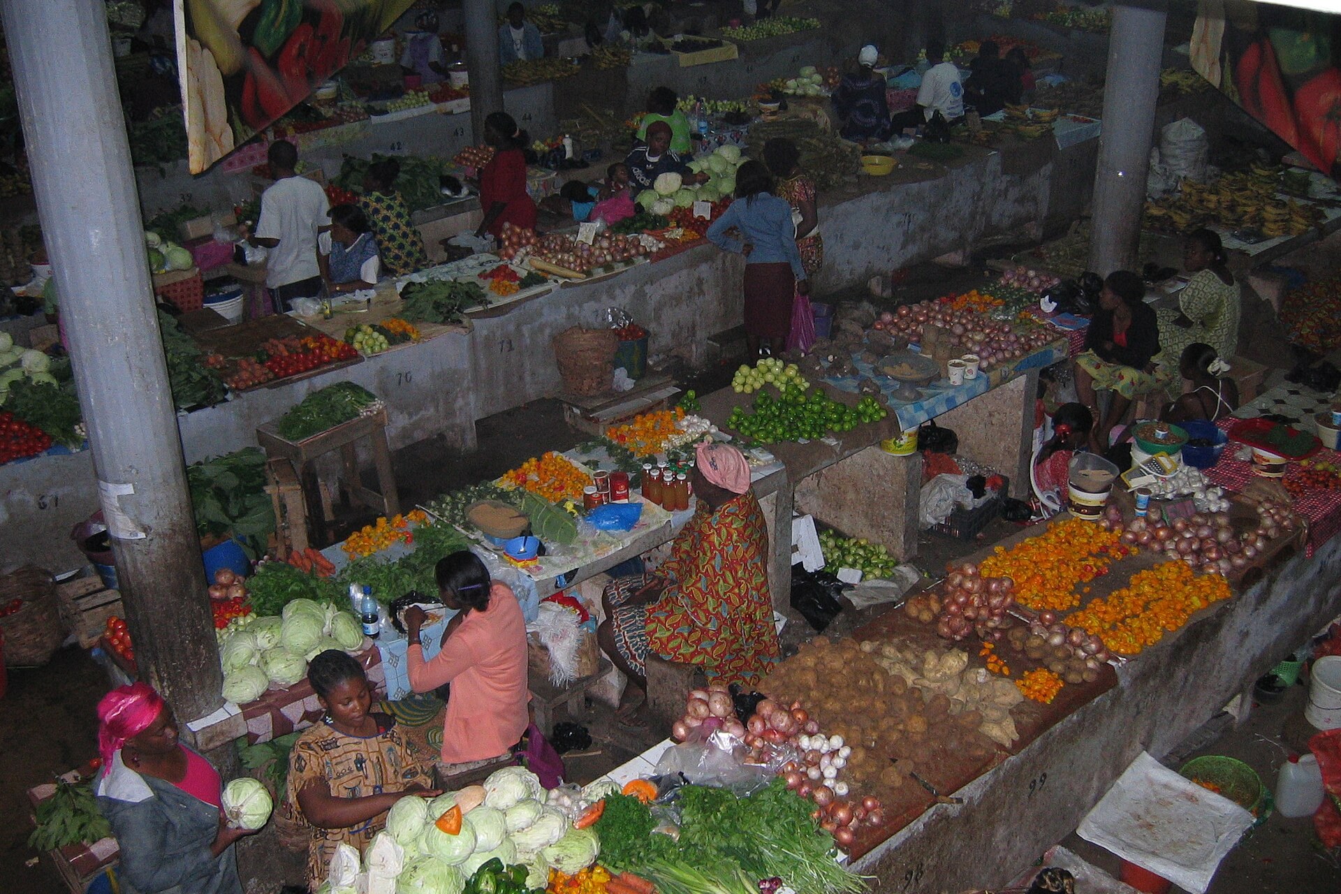 Vendors selling vegetables, onions and cabbages at stalls inside the Nkembo market in Libreville, Gabon