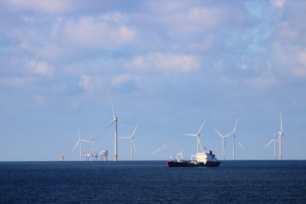 Offshore wind farm and a tanker at sea, illustrating the energy backdrop for Latin America markets