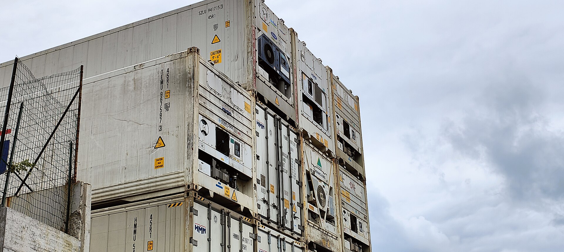 Stacked refrigerated shipping containers at the port of Genoa Pra’, Italy