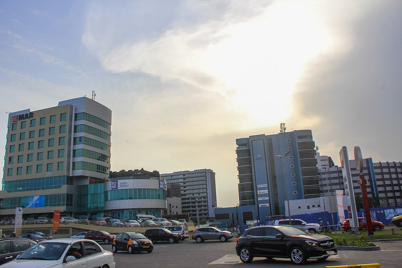 Office towers, a shopping centre and cars at a busy junction in Accra, Ghana