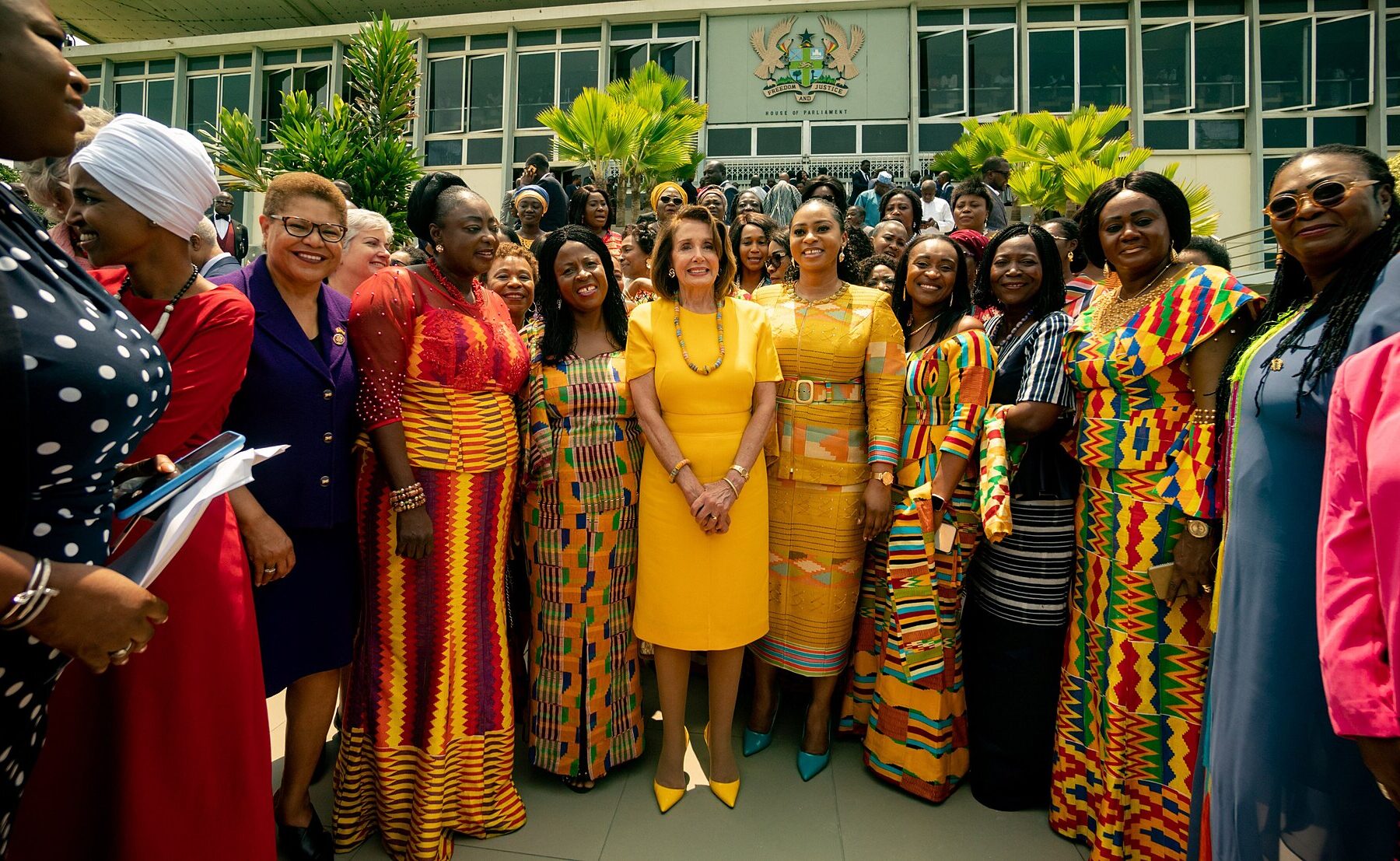 Ghanaian women lawmakers gathered outside Parliament House in Accra, Ghana, with the building emblem behind them
