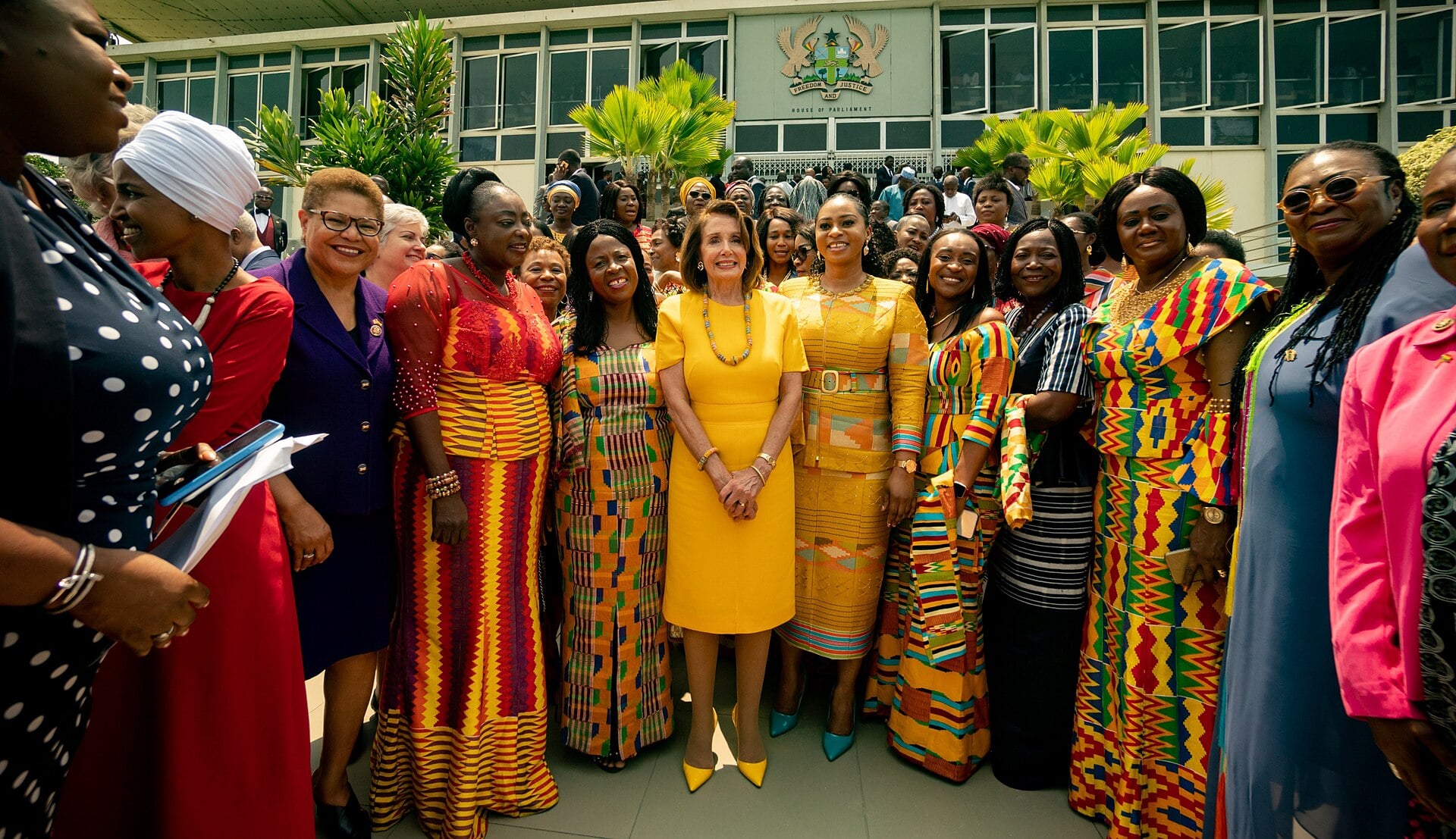 Ghanaian women lawmakers gathered outside Parliament House in Accra, Ghana, with the building emblem behind them