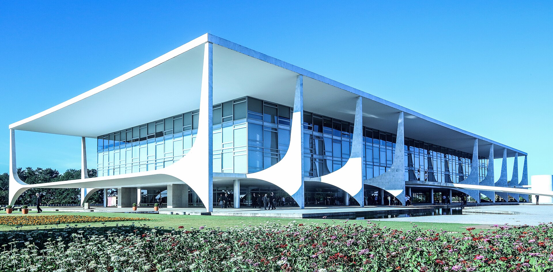 The Planalto Palace in Brasília, a low white building with curved columns and glass walls under a blue sky