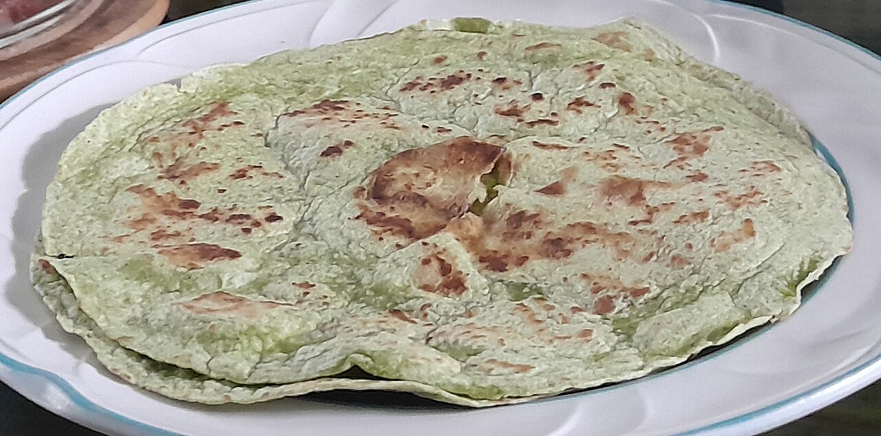 A semi-seared green Mission Foods tortilla served on a white plate