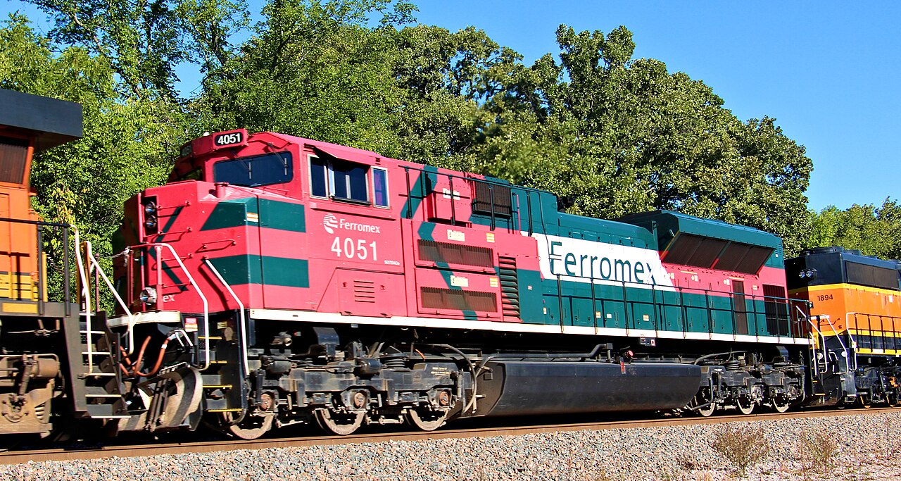 A red and green Ferromex diesel locomotive, number 4051, pulling a freight train
