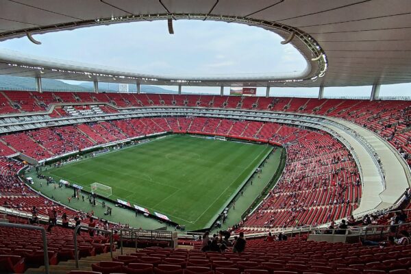Interior of Estadio Akron in Guadalajara with red seating around the pitch