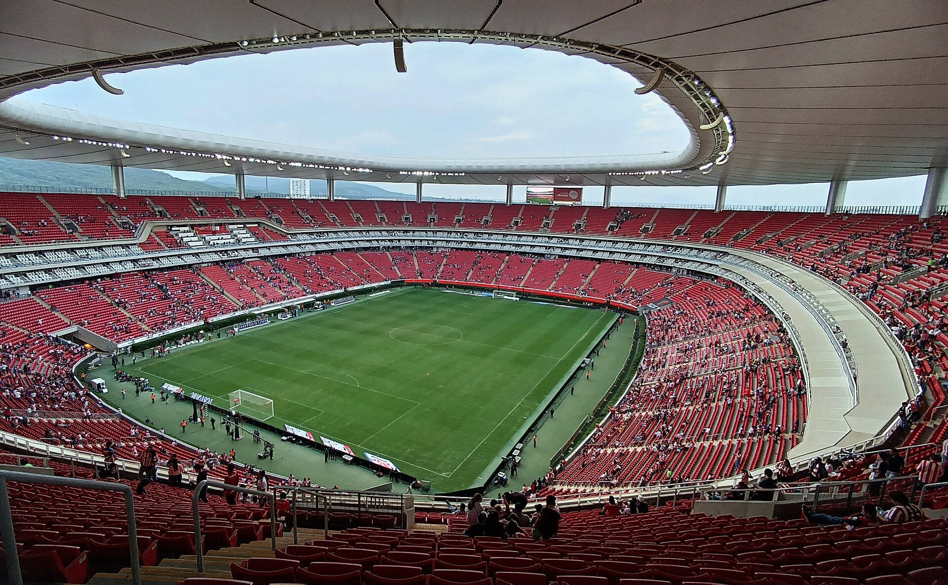 Interior of Estadio Akron in Guadalajara with red seating around the pitch