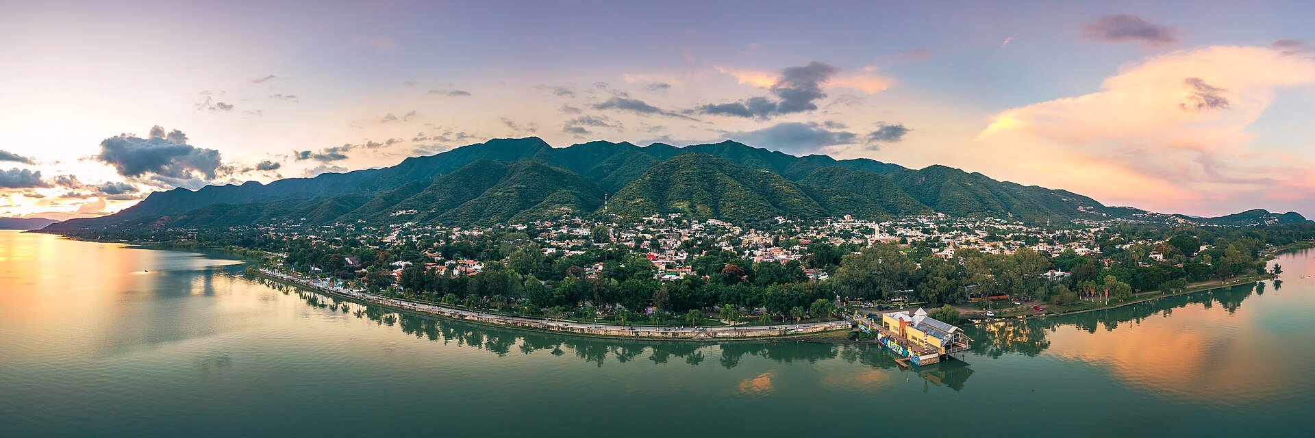 Aerial panorama of the Ajijic lakeside promenade on Lake Chapala with mountains behind