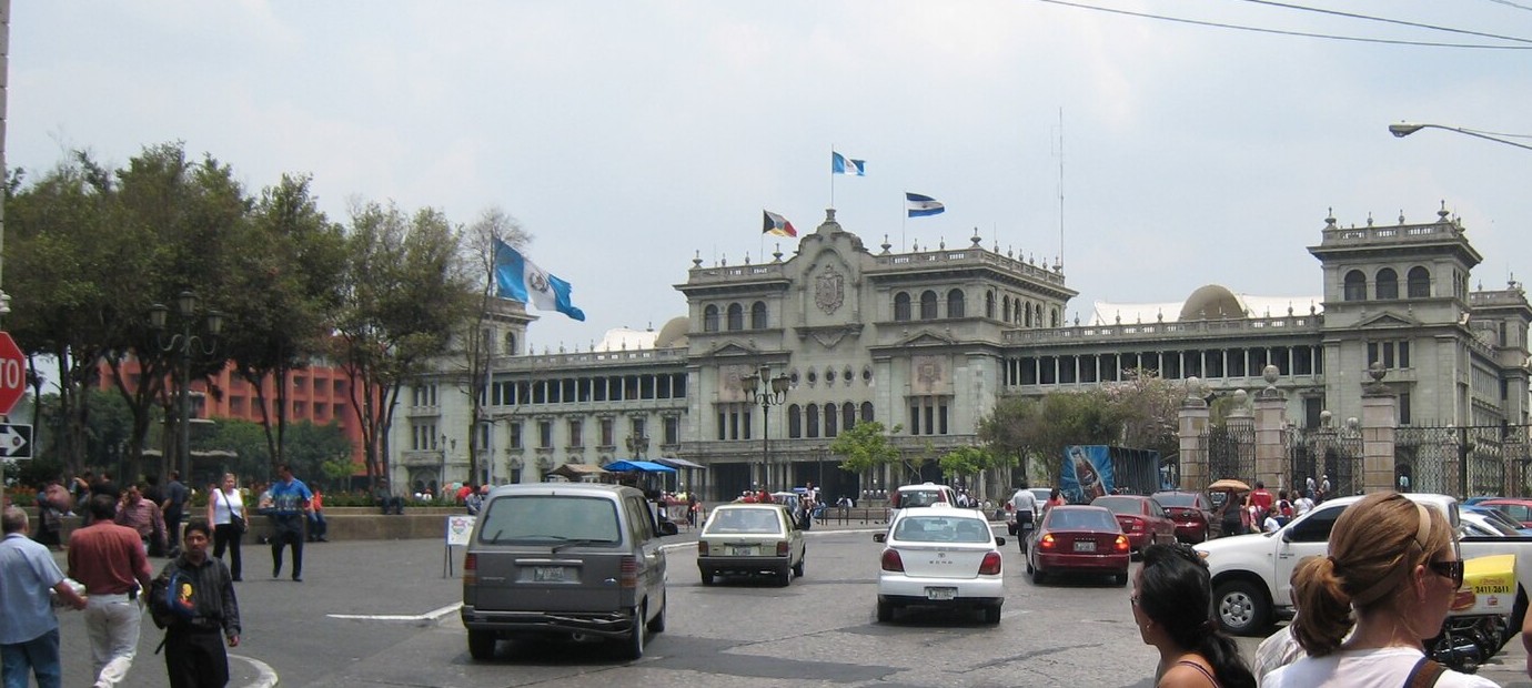The Palacio Nacional de la Cultura seen across traffic from a street corner in central Guatemala City