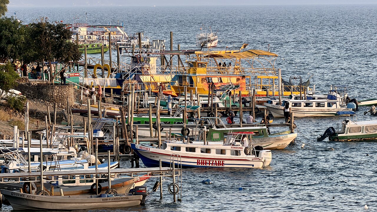 Colourful tourist boats moored at wooden docks on Lake Atitlán at Panajachel, Guatemala