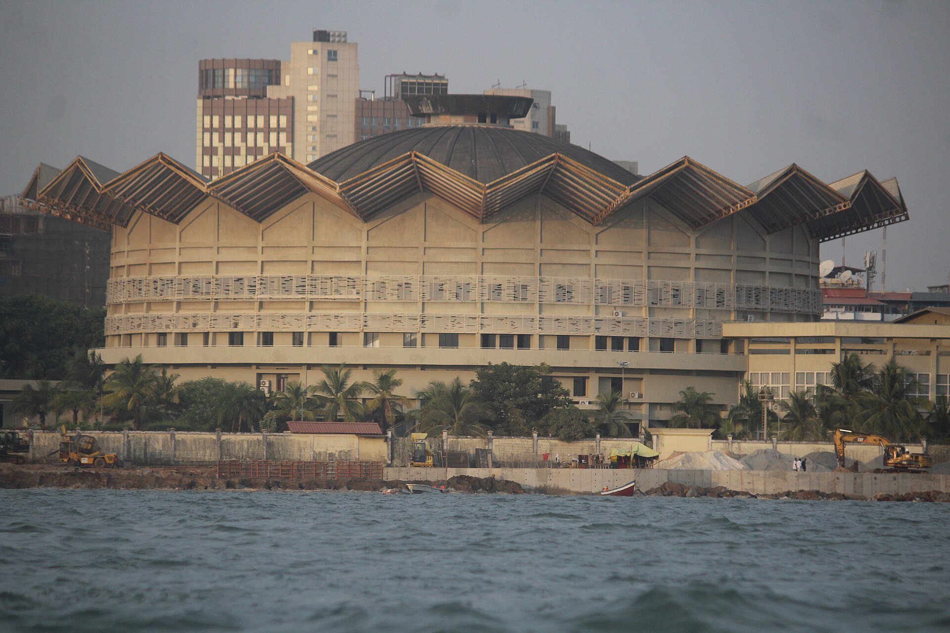 The domed Palais Mohammed V, the presidential palace in Conakry, seen from the sea with palm trees in front