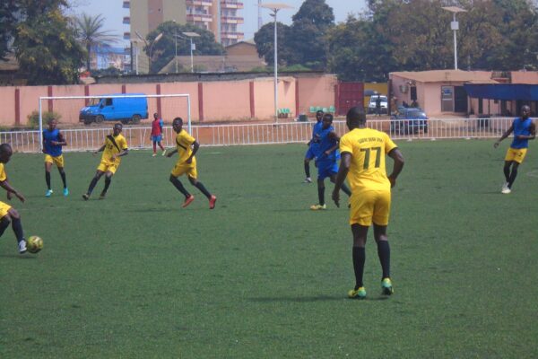 Footballers in a match at the annexe pitch of the Stade du 28 Septembre in Conakry, Guinea