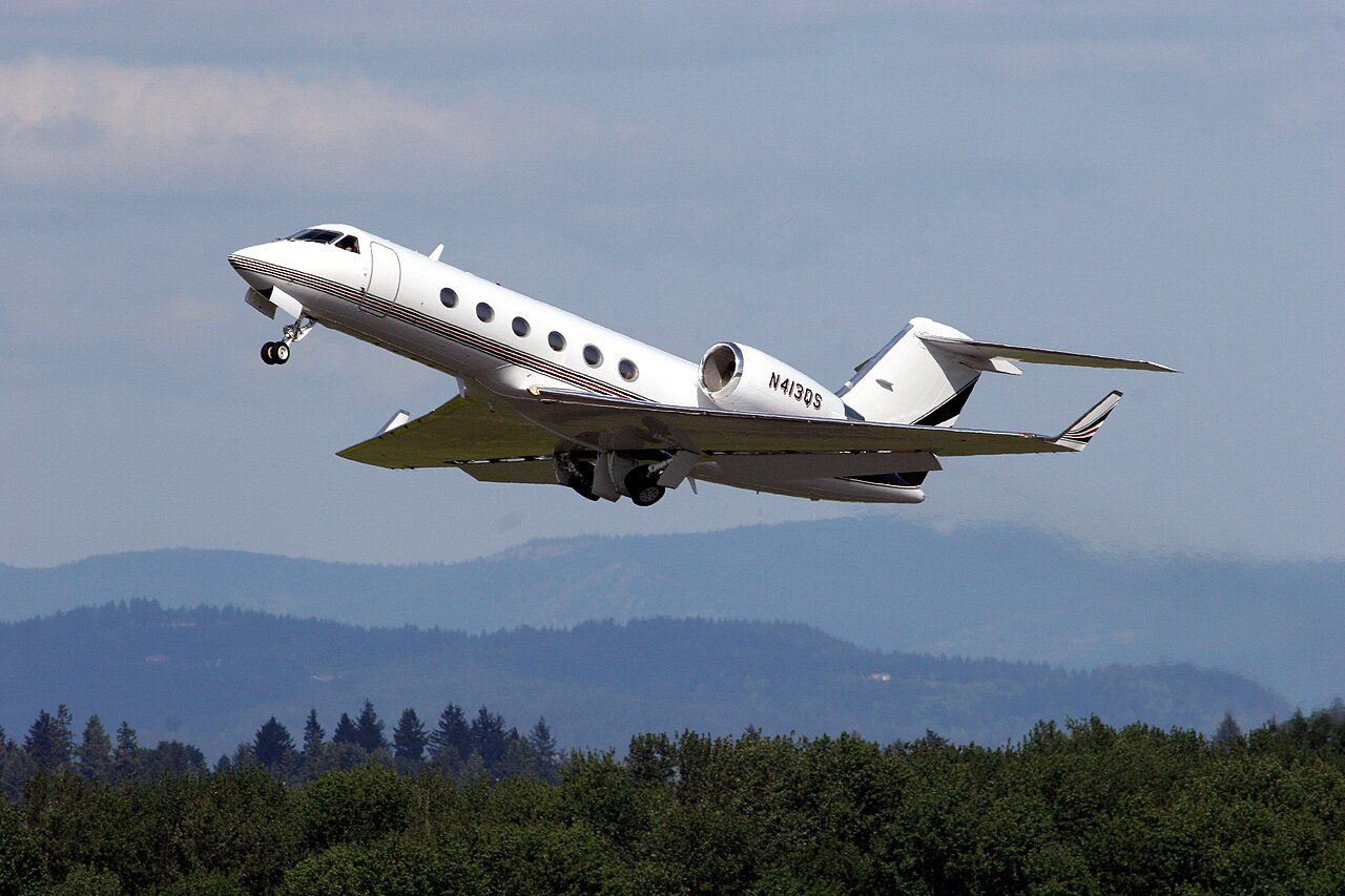 A white Gulfstream G400 private jet climbing after takeoff, file photo