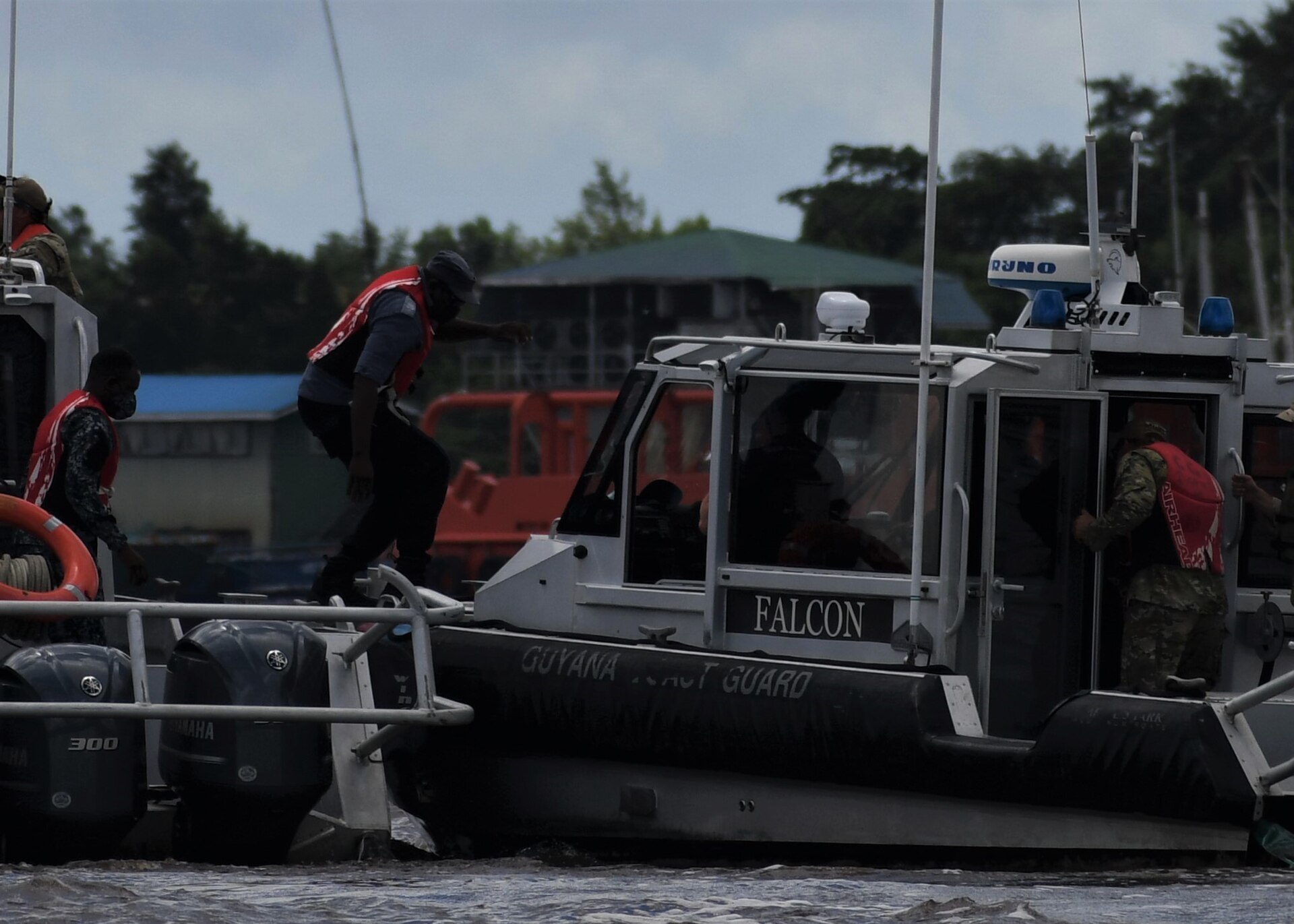Guyana Coast Guard crew aboard a patrol boat on the Demerara River during a boarding drill