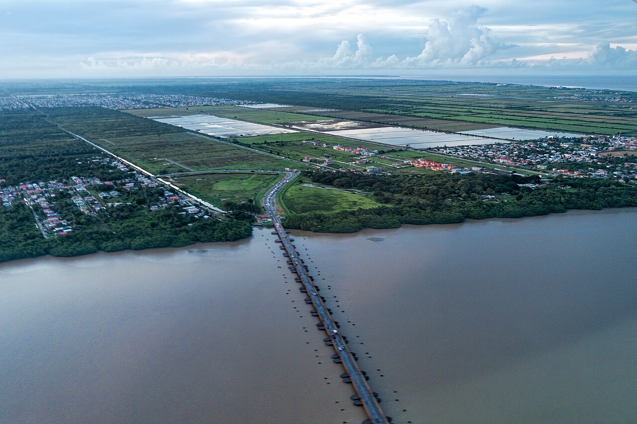 Aerial view of the Demerara Harbour Bridge, a floating road crossing over the brown Demerara River