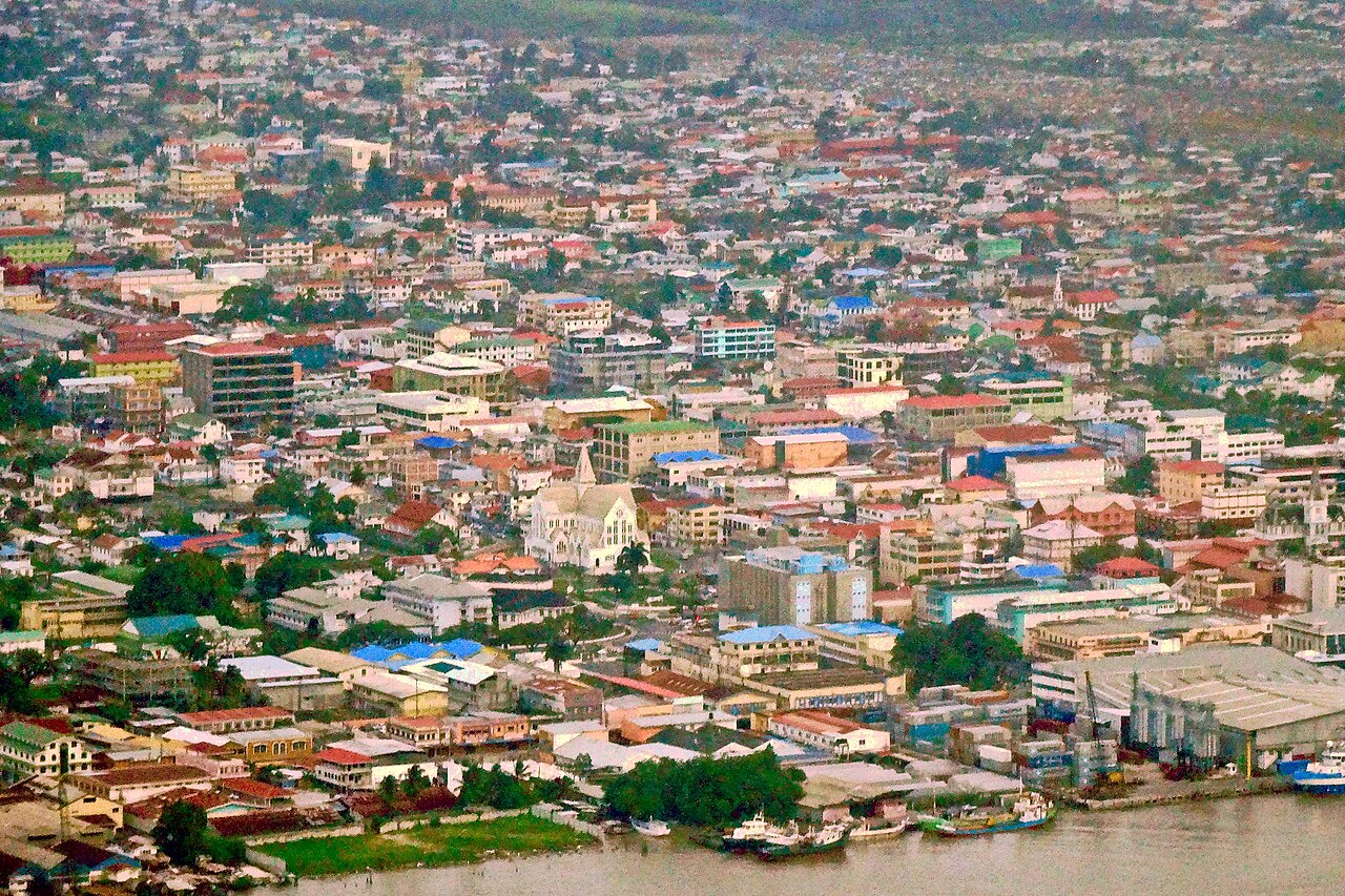 Aerial view of downtown Georgetown, Guyana, with the white St George's Cathedral among low-rise buildings by the river