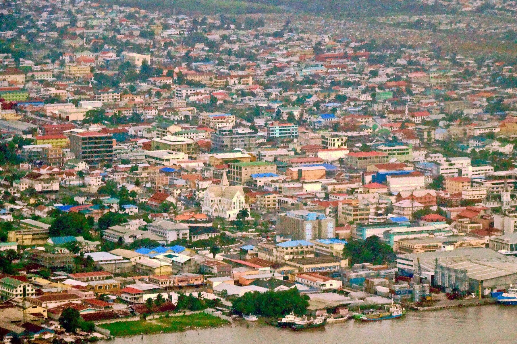 Aerial view of central Georgetown, Guyana, with St George's Cathedral and wharves along the Demerara River