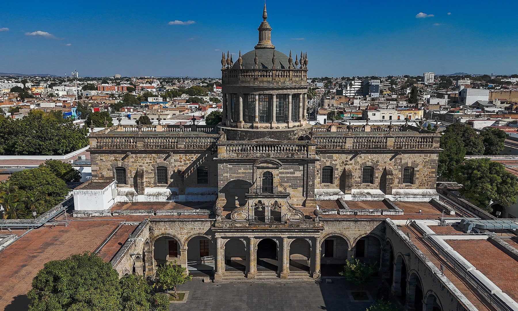 Aerial view of the domed chapel and courtyards of the Hospicio Cabañas in Guadalajara with the city behind