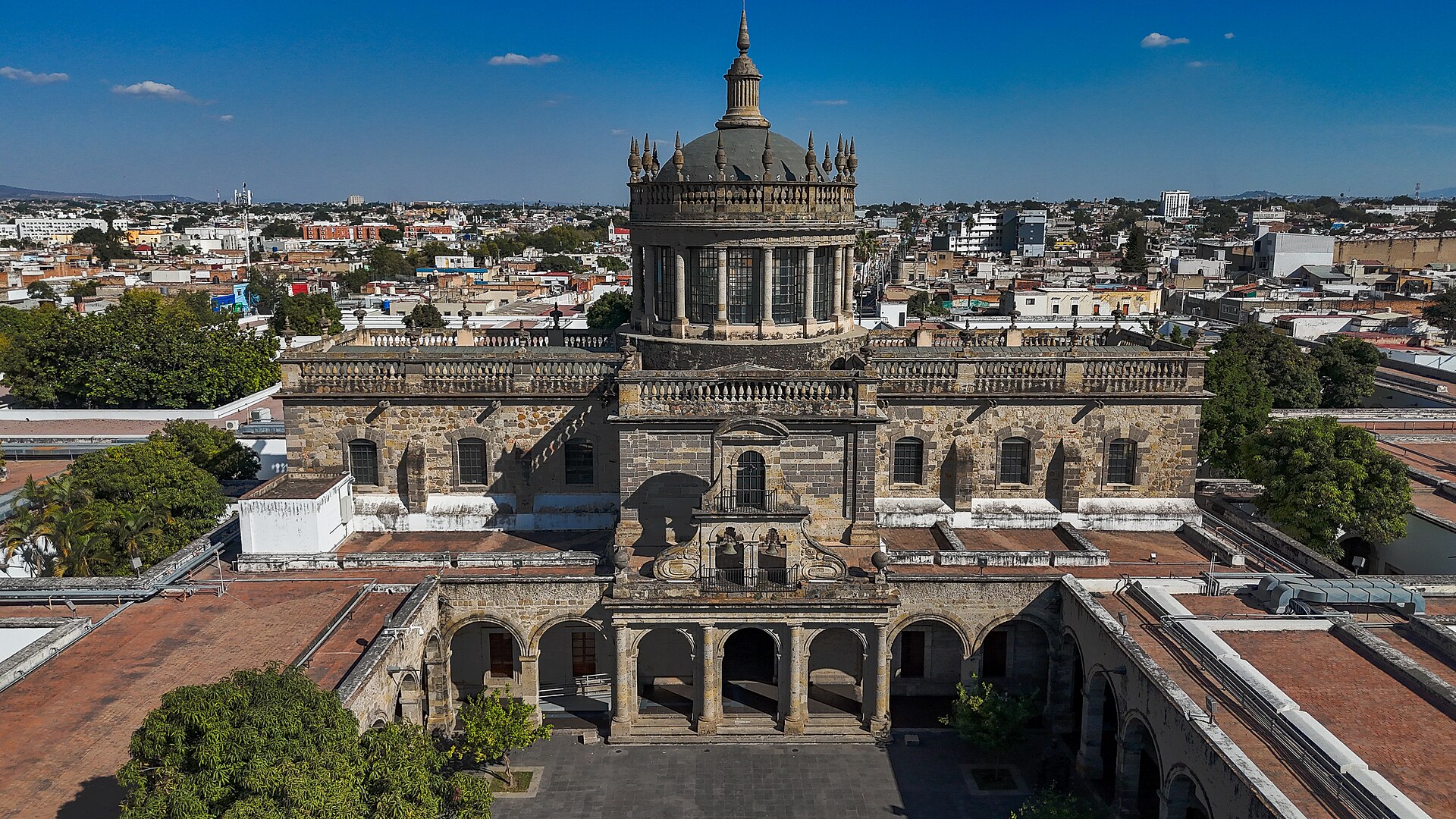 Aerial view of the domed chapel and courtyards of the Hospicio Cabañas in Guadalajara with the city behind
