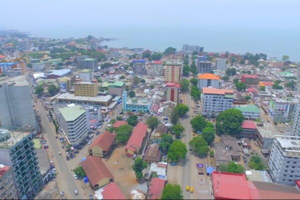 Aerial view of central Conakry, Guinea, with a mosque, apartment blocks and the Atlantic coast