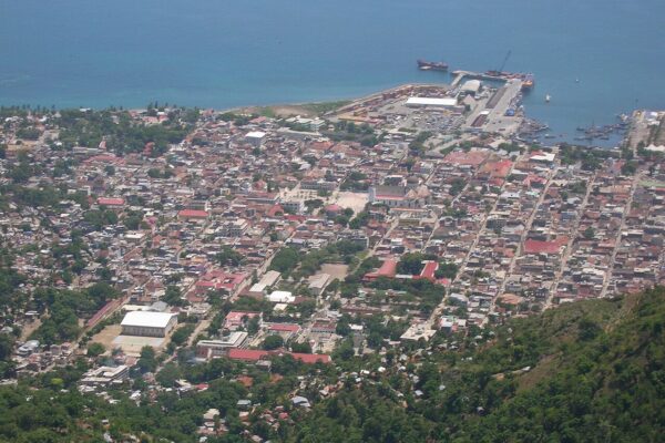 Aerial view of Cap-Haïtien in northern Haiti, with the cathedral in the old centre and cargo ships at the harbour pier.
