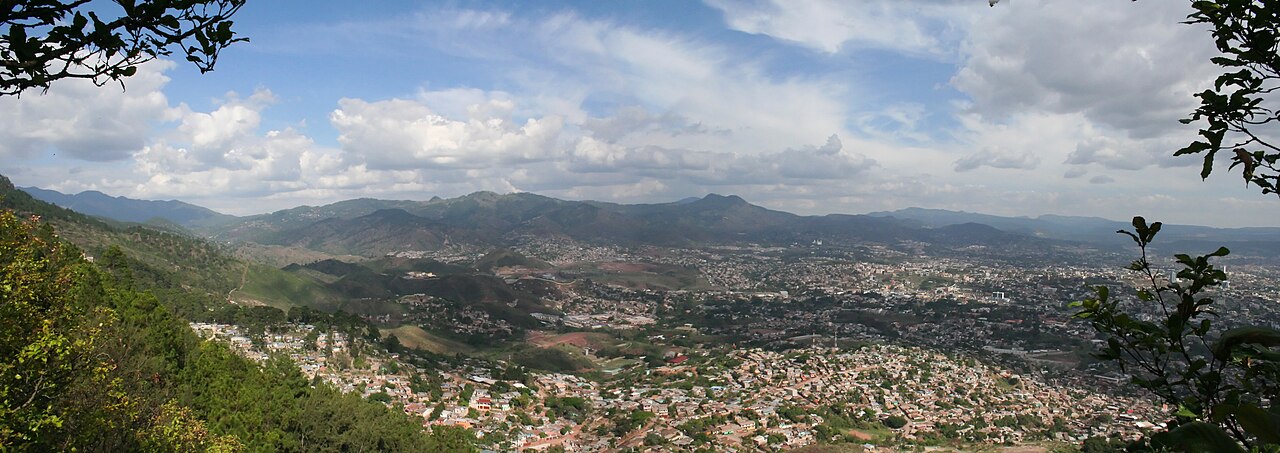 Panoramic view of Tegucigalpa, the capital of Honduras, spread across a valley ringed by green mountains
