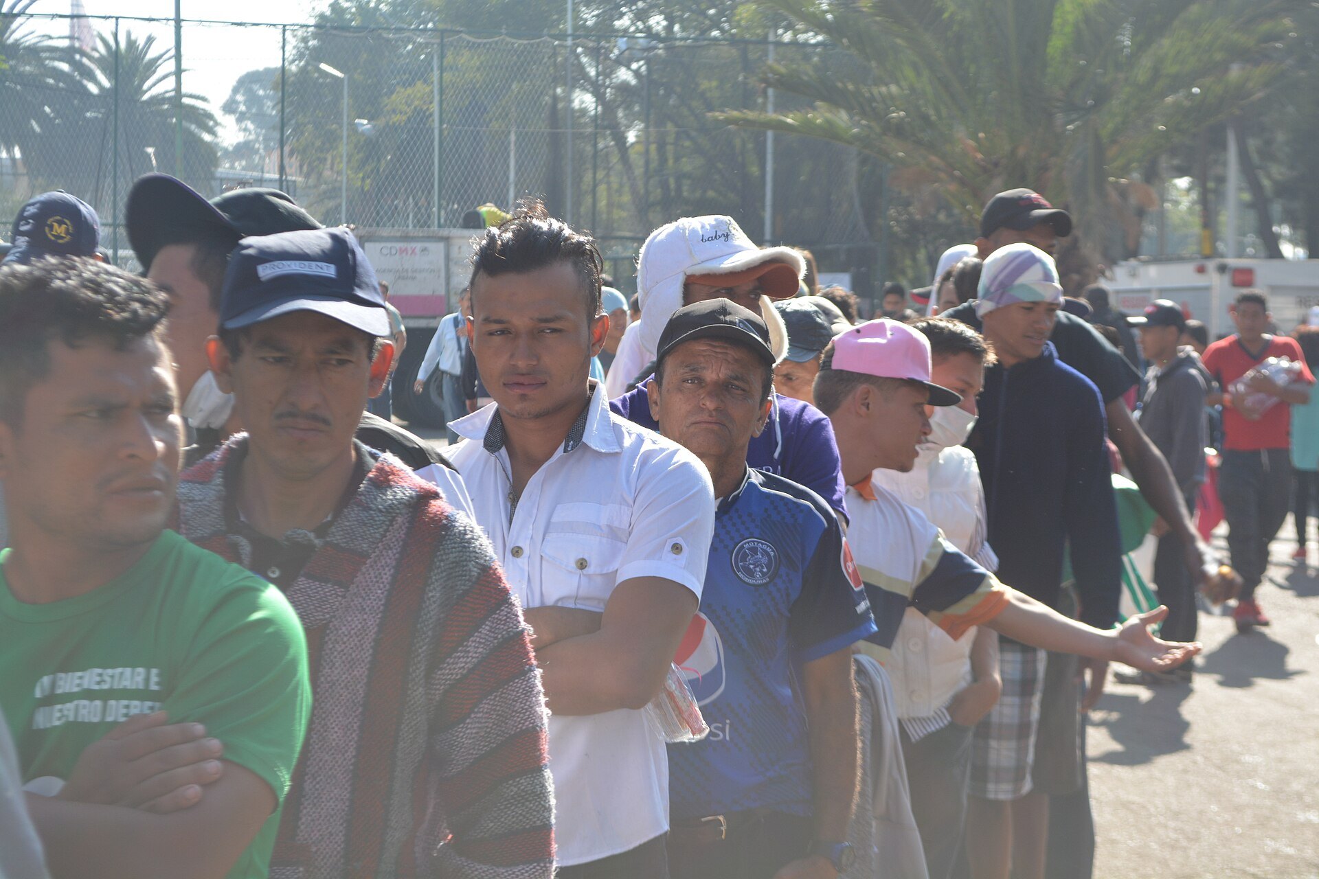 Honduran and other Central American migrants from a 2018 caravan queue for breakfast at a temporary camp in Mexico City