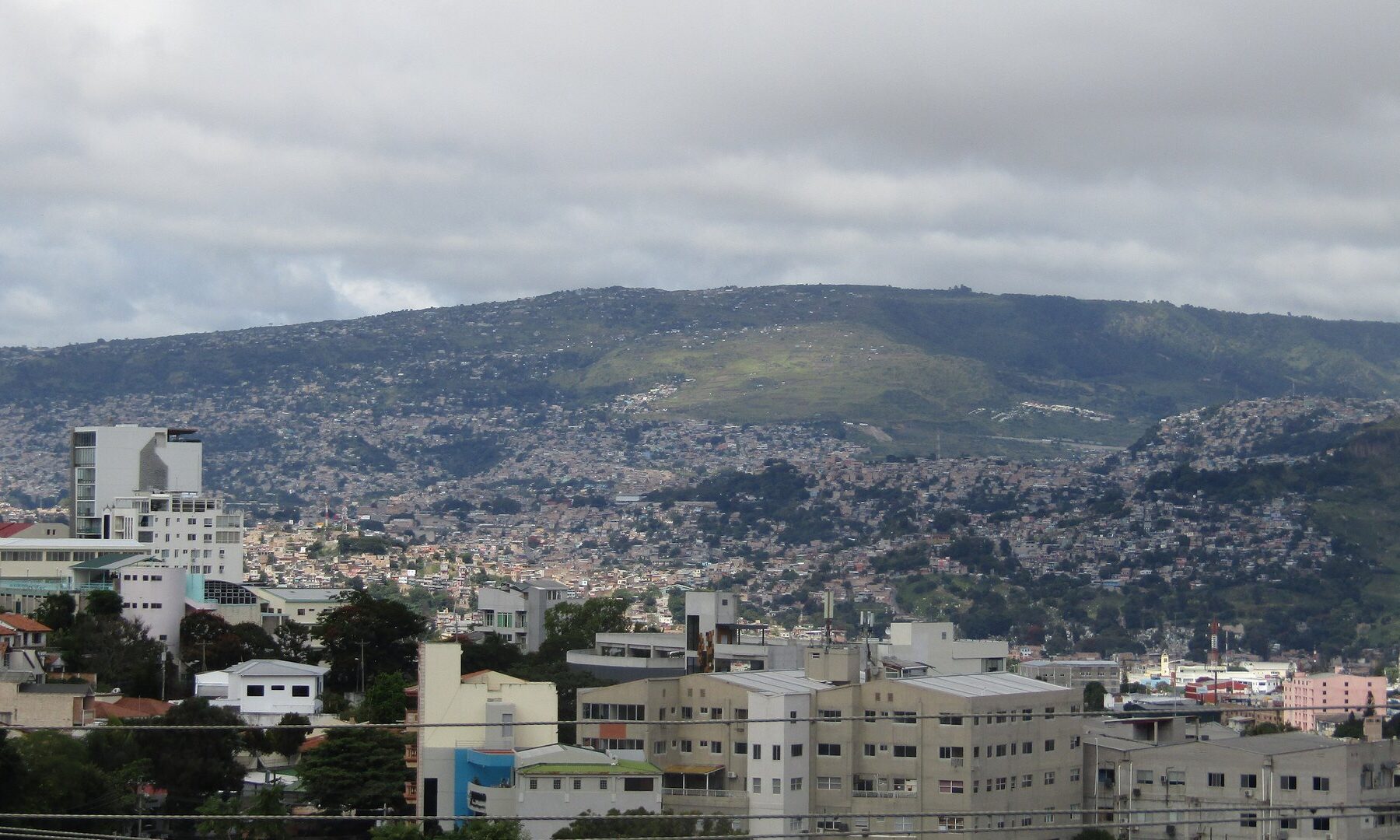 Hillside neighbourhoods of Tegucigalpa, the capital of Honduras, below the Pedregal hill under a cloudy sky
