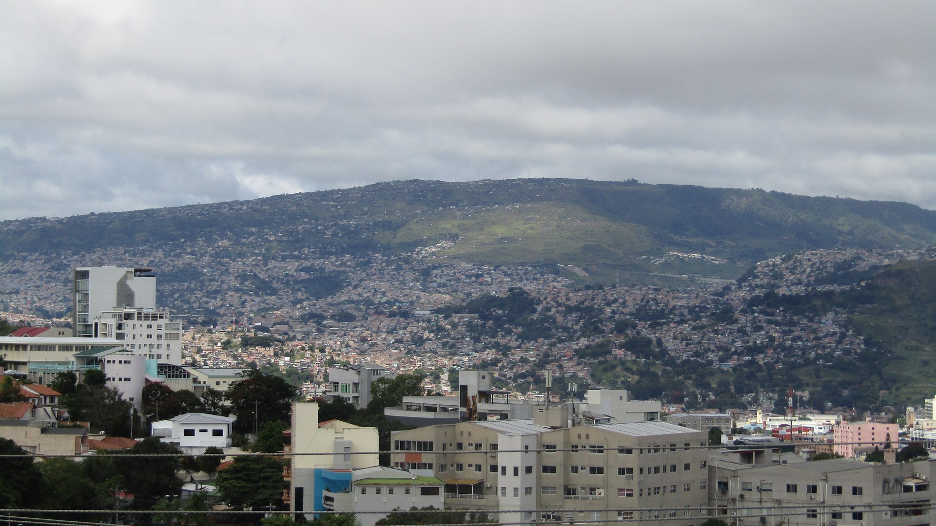 Hillside neighbourhoods of Tegucigalpa, the capital of Honduras, below the Pedregal hill under a cloudy sky