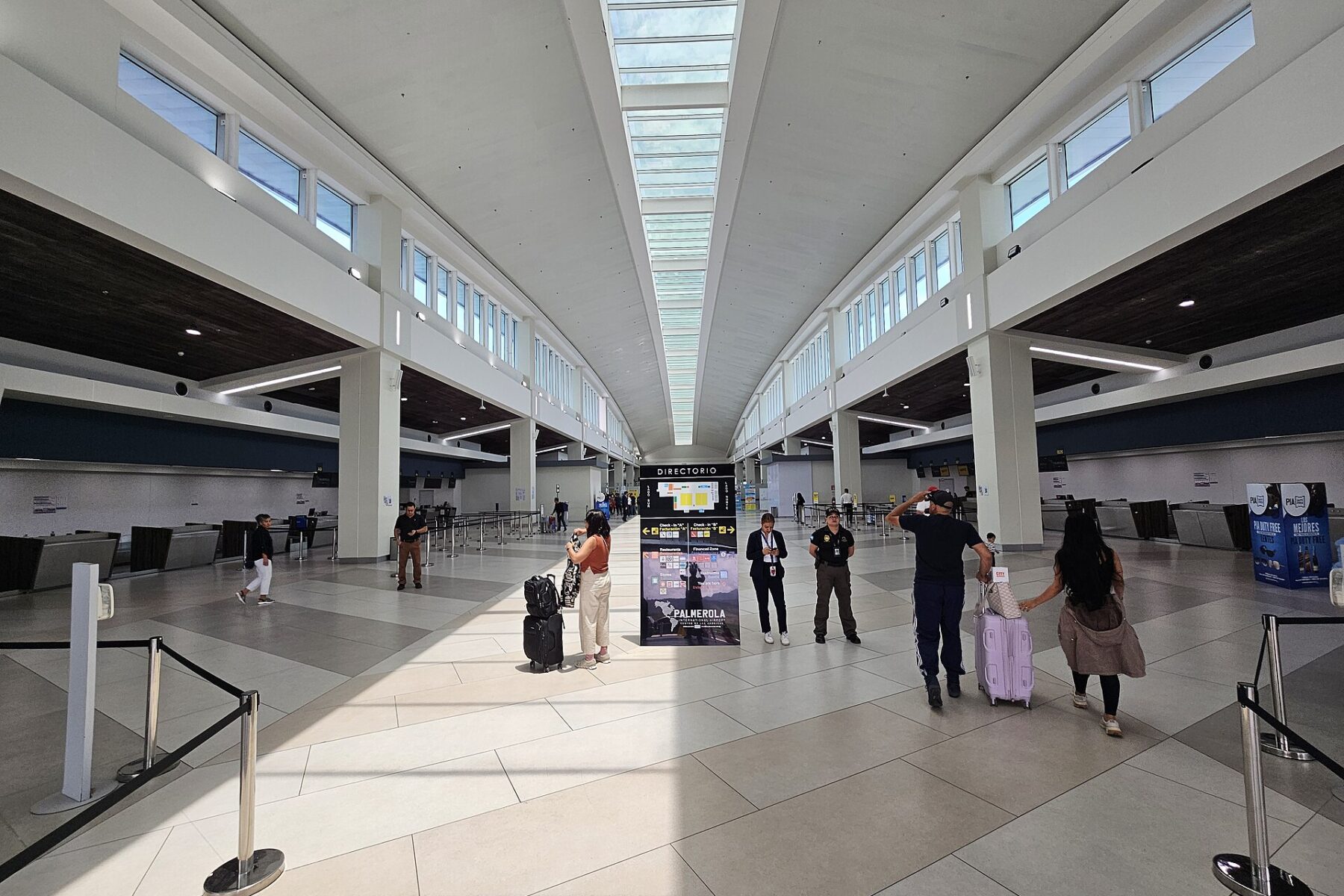 Travellers with luggage in the check-in hall of Palmerola International Airport near Comayagua, Honduras