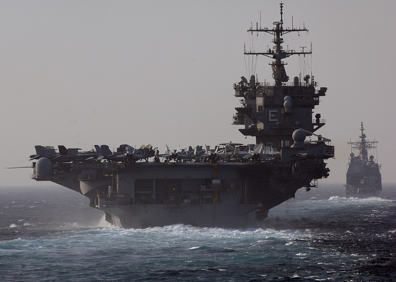 The aircraft carrier USS Enterprise and the cruiser USS Vicksburg sail through the Bab el-Mandeb strait