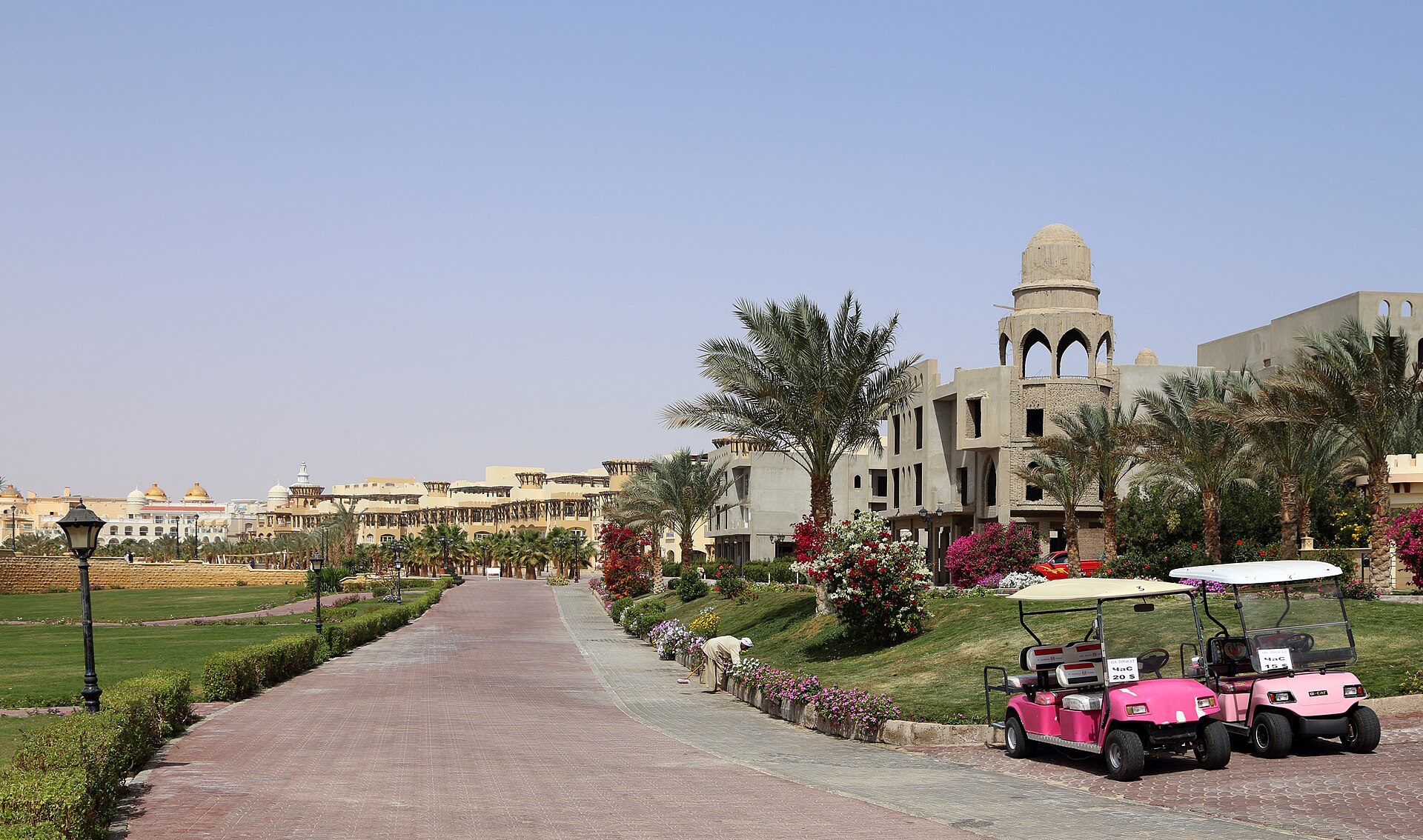 Palm-lined promenade with hotels and golf carts in Sahl Hasheesh, south of Hurghada, Egypt