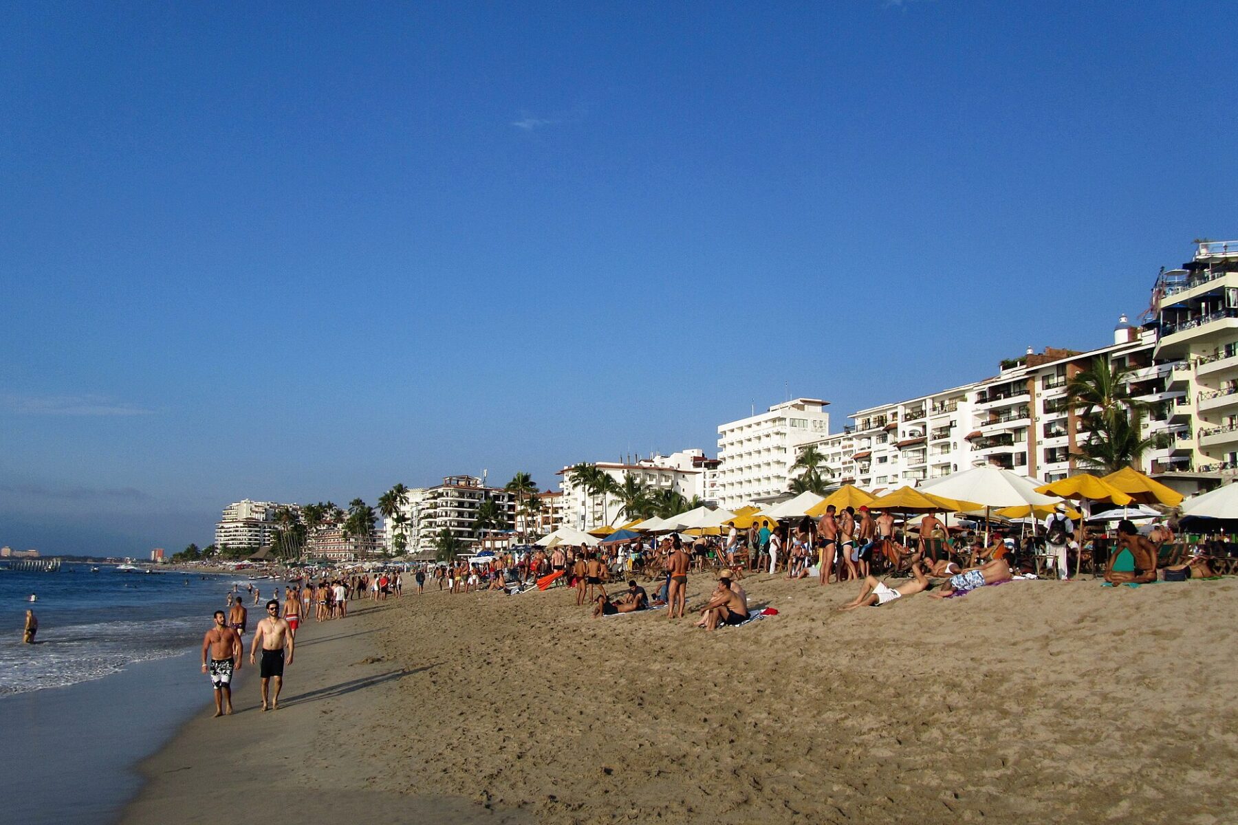 Sunbathers and hotels along Playa de los Muertos beach in Puerto Vallarta, Jalisco, Mexico