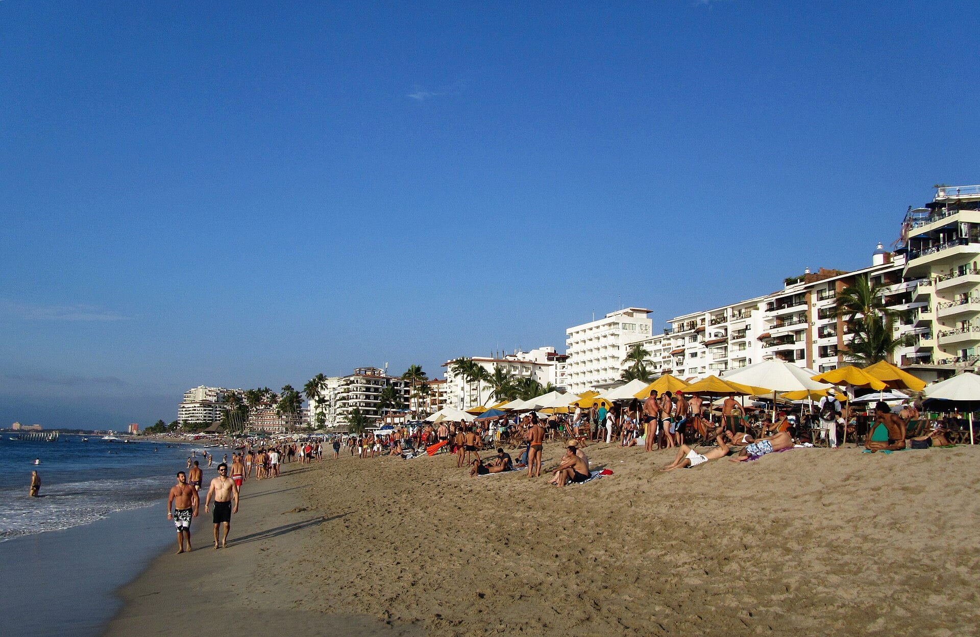 Sunbathers and hotels along Playa de los Muertos beach in Puerto Vallarta, Jalisco, Mexico