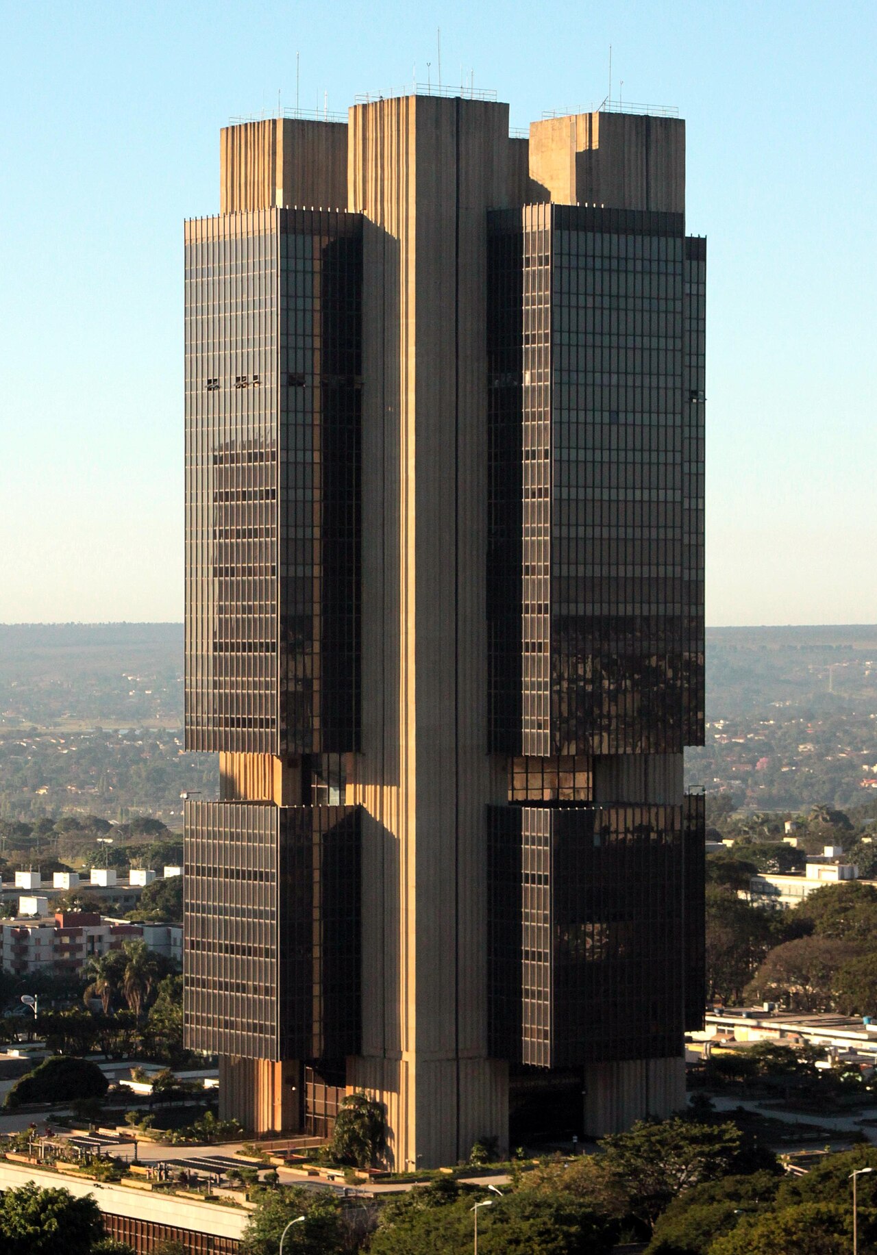 The dark glass and concrete headquarters tower of the Banco Central do Brasil in Brasília, seen from a raised viewpoint