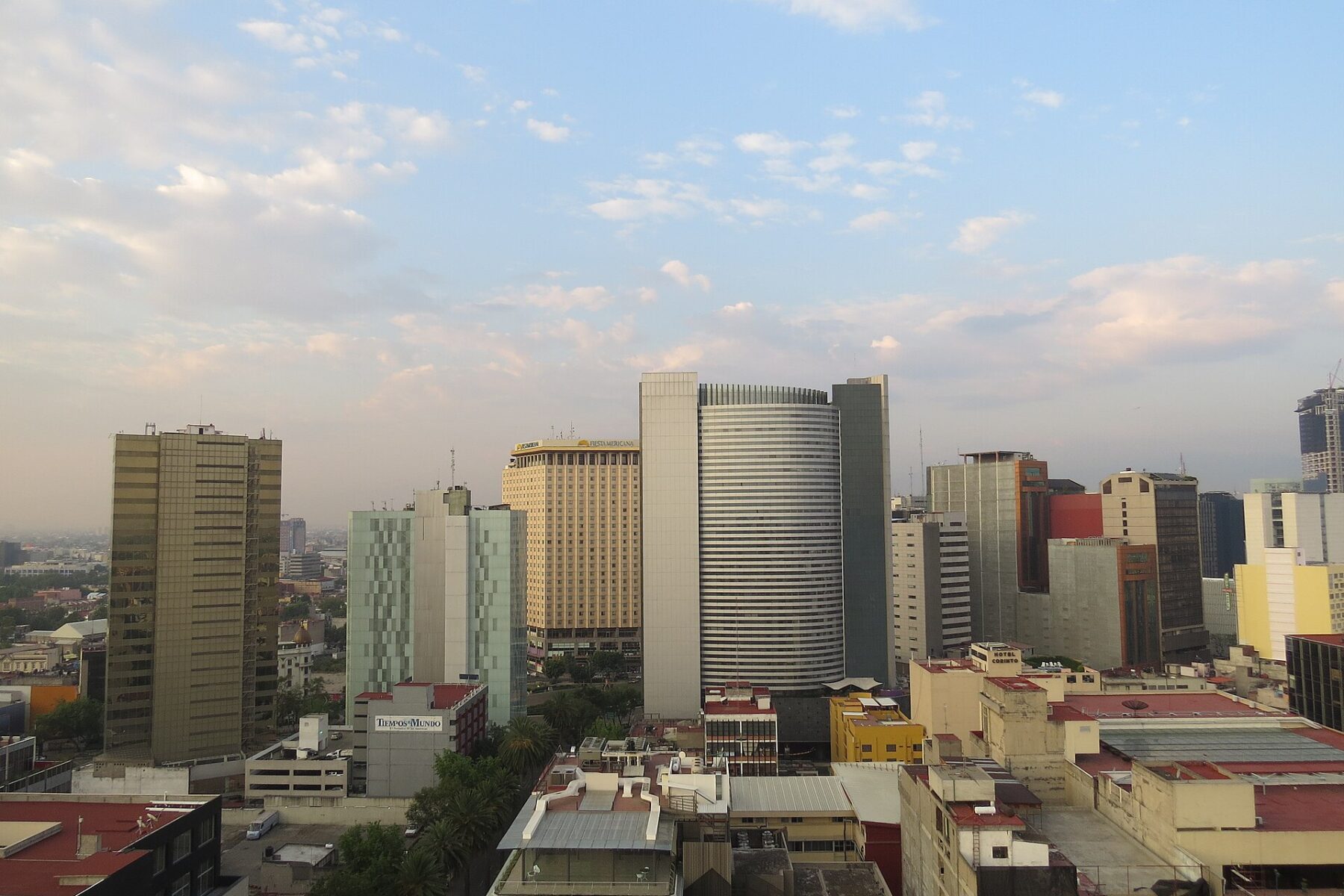 Office towers along Paseo de la Reforma in Mexico City under a morning sky