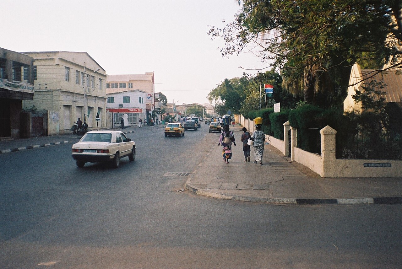 Independence Drive in Banjul, The Gambia, with cars, pedestrians and the Gambian flag