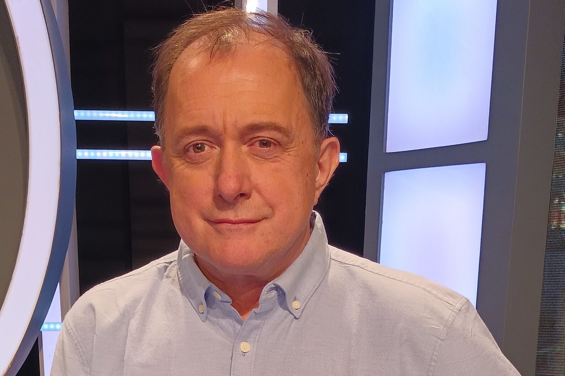 Iván Poduje, Chile's housing minister, in a light blue shirt in a television studio