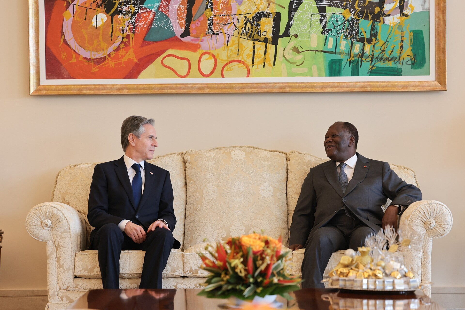 Then US Secretary of State Antony Blinken and Ivorian President Alassane Ouattara sitting on a sofa in conversation in Abidjan
