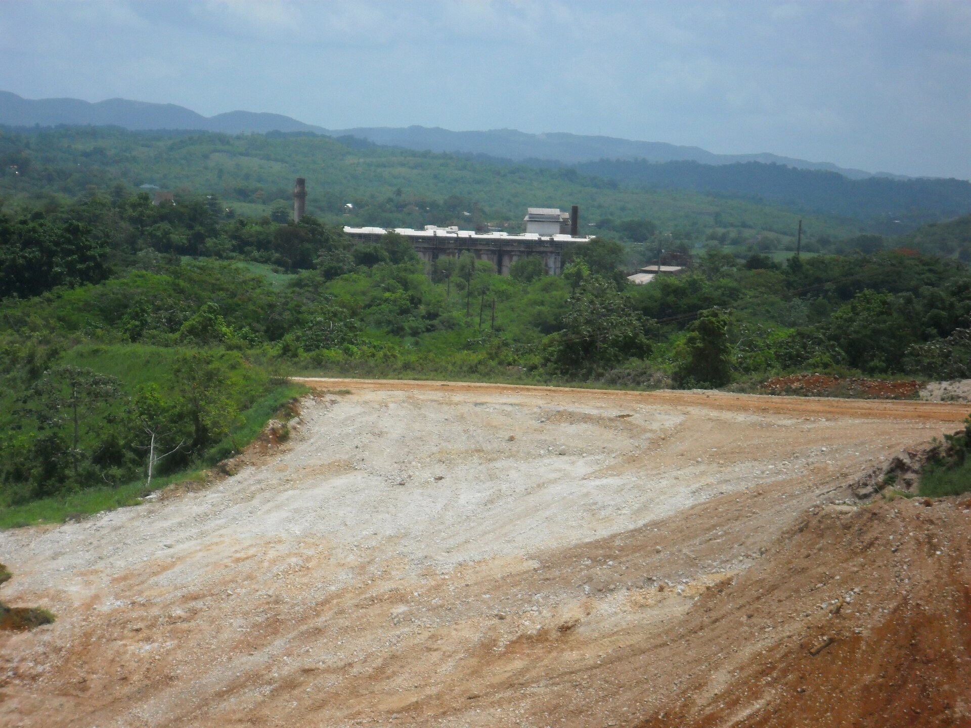 Windalco alumina plant at Kirkvine in Jamaica behind a bauxite mining road