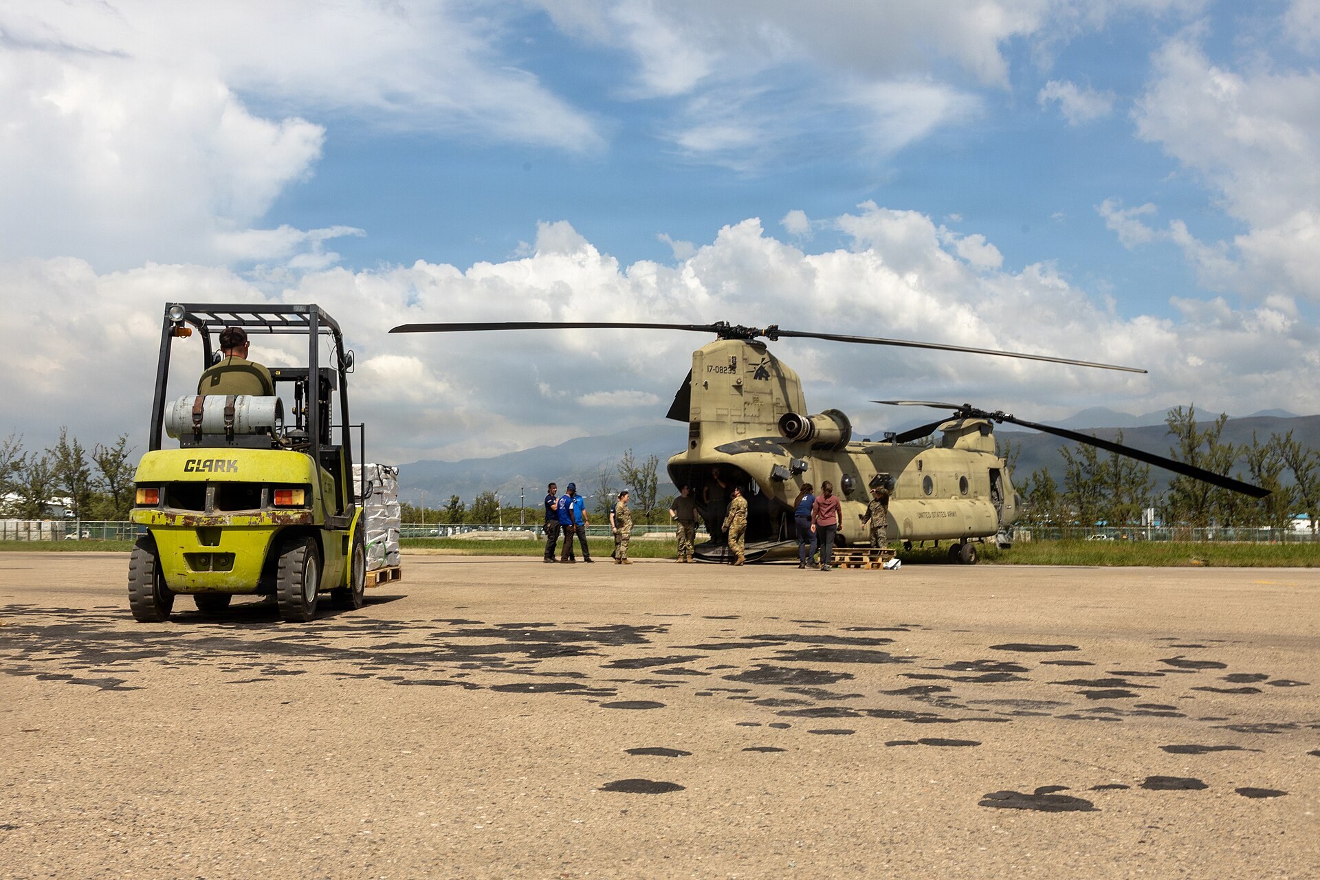 CH-47 Chinook helicopter and a forklift loading relief supplies in Jamaica