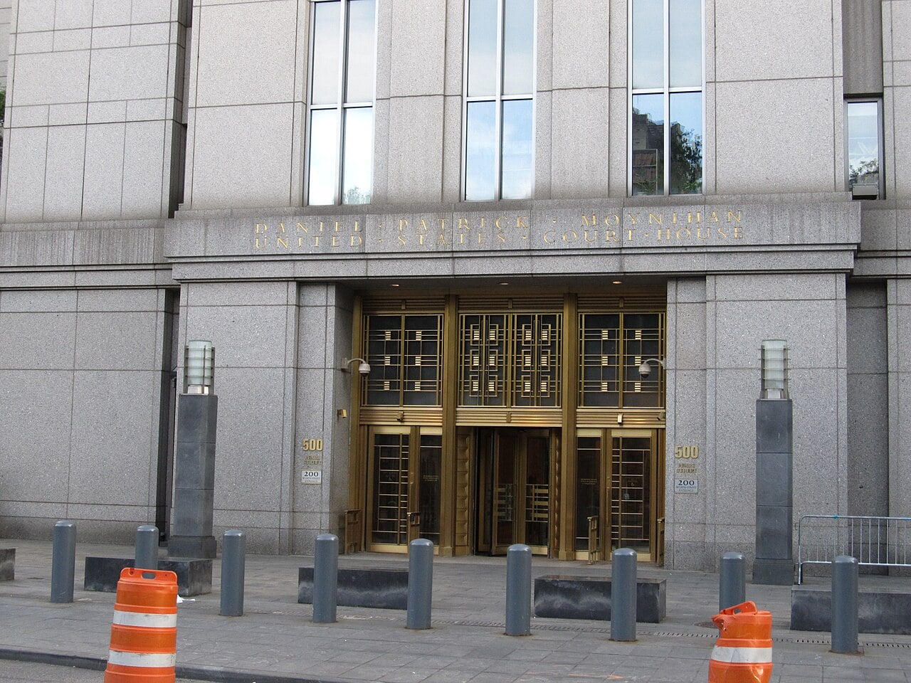 Entrance of the Daniel Patrick Moynihan United States Courthouse at 500 Pearl Street in Lower Manhattan, with bronze doors and security bollards