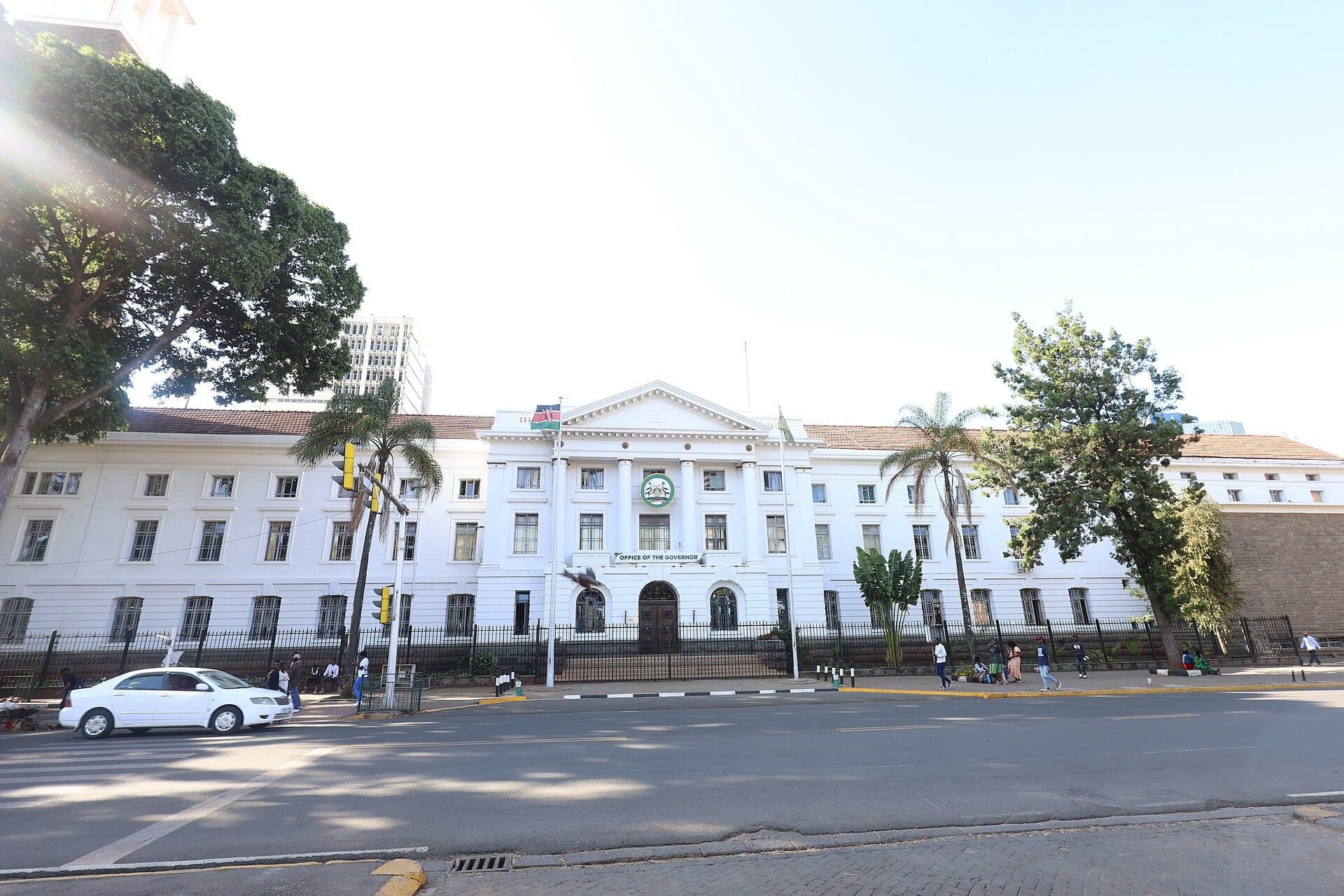 A white colonial-style building in central Nairobi with an Office of the Governor sign and a Kenyan flag