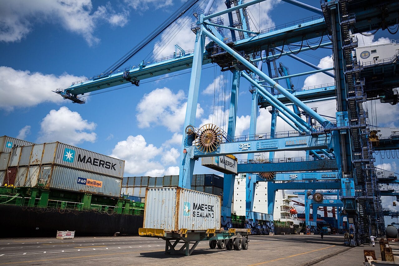 Blue container cranes and Maersk shipping containers on the quay at the port of Mombasa